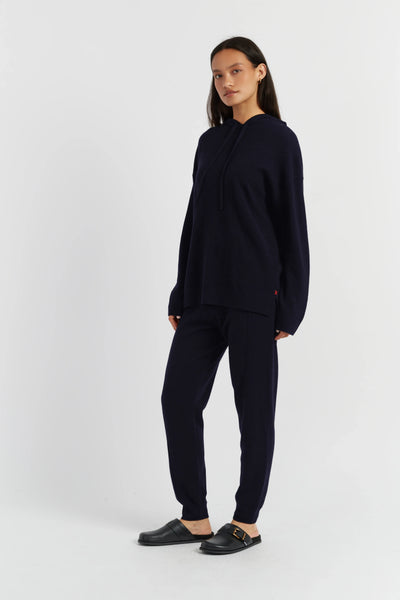 Woman wearing a navy blue outfit on a white background