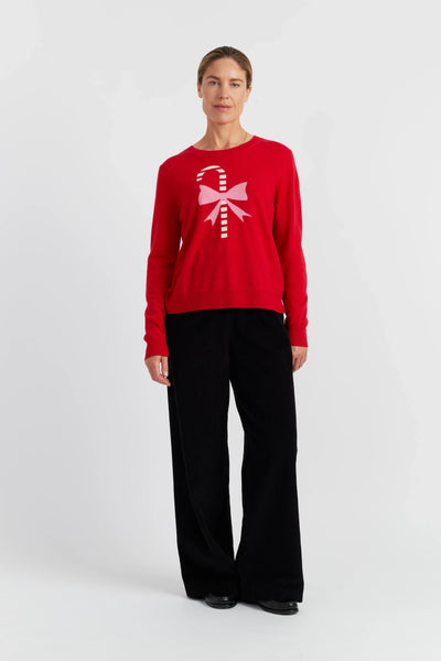 Person wearing a red sweater with a white design on a white background
