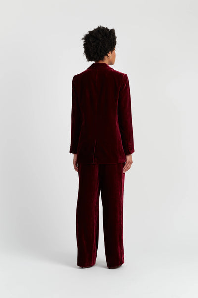 Person wearing a burgundy suit on a white background