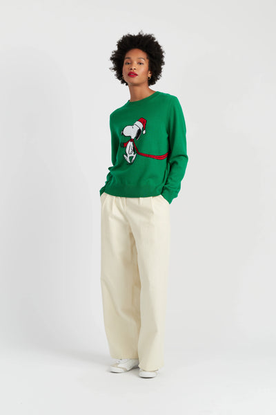 Person wearing a green sweater with a graphic design on a white background