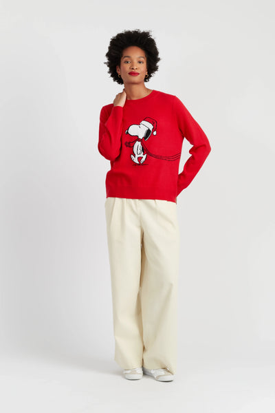 Person wearing a red sweater with a graphic design on a white background