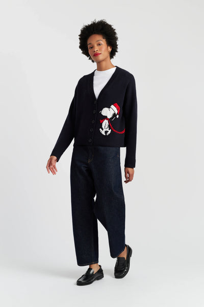 Person wearing a black cardigan with a graphic design on a white background