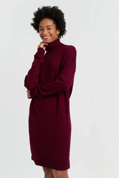 Woman wearing a burgundy dress against a white background