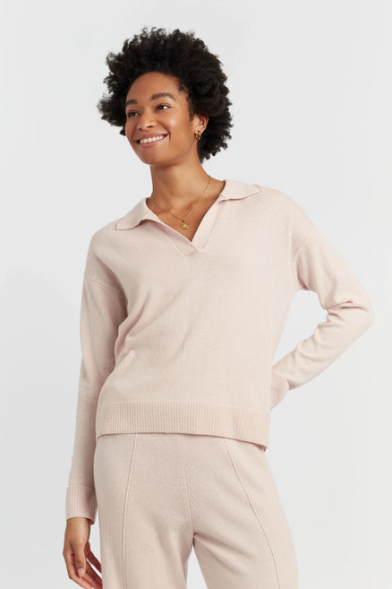 Woman wearing a light pink long-sleeve top and pants on a white background