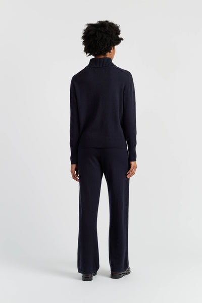 Person wearing a black outfit on a white background