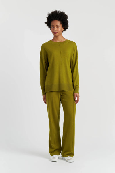 Person wearing a green outfit on a white background