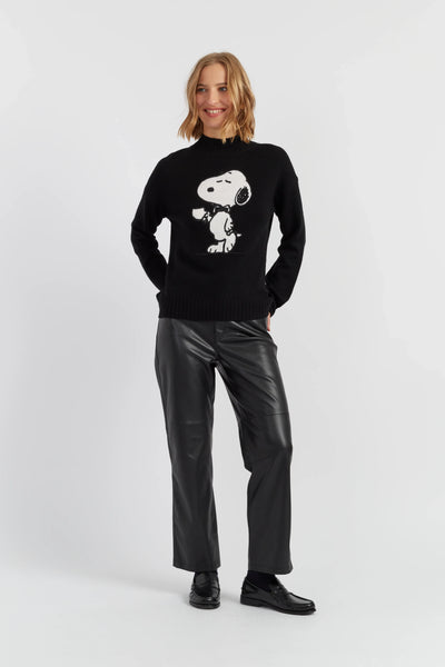 Person wearing a black sweater with a white graphic design on a white background