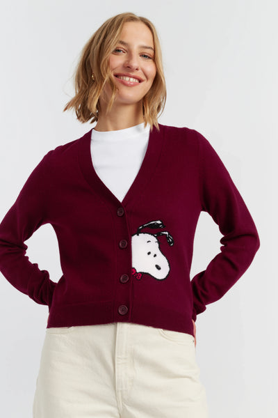 Woman wearing a burgundy cardigan with a snowman design on a white background