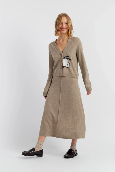 Woman wearing a beige dress with a cartoon character on a white background