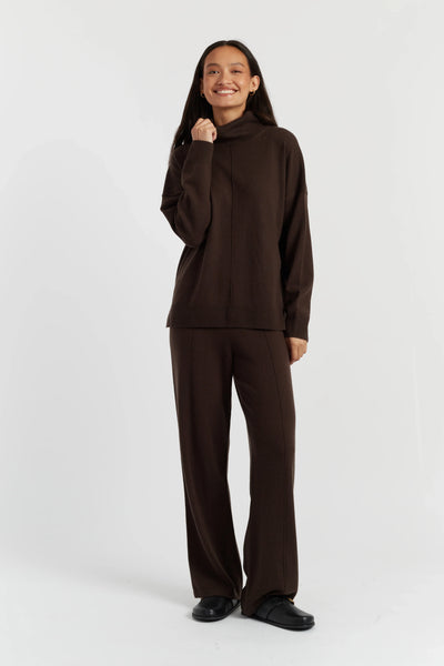 Person wearing a brown outfit on a white background