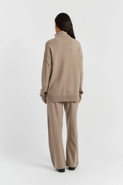 Woman wearing a beige suit on a white background