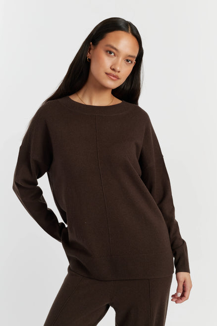 Woman wearing a brown sweater on a white background
