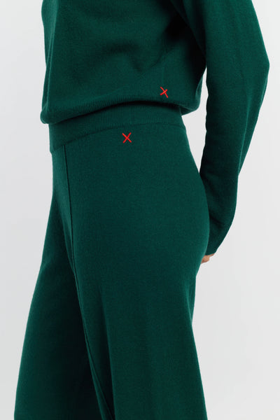 Green outfit with red 'X' markers on a white background
