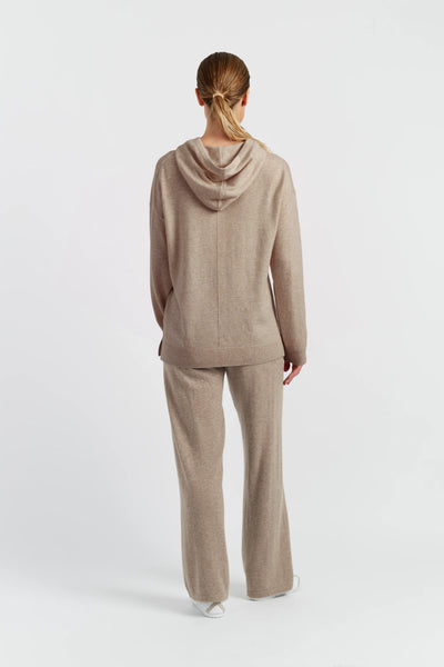 Woman wearing a beige hoodie on a white background