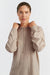 Woman wearing a beige hoodie on a white background