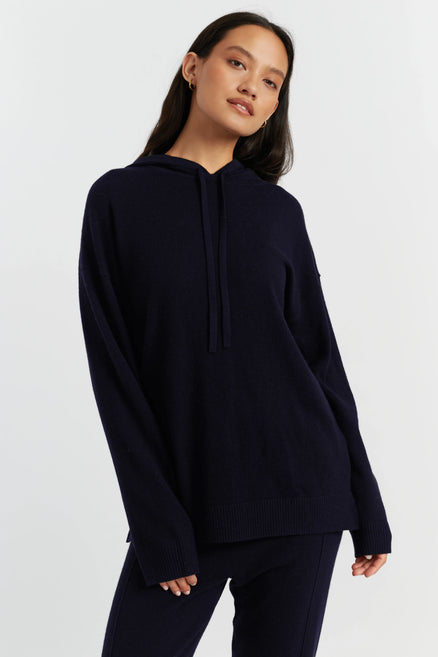 Woman wearing a navy blue hoodie on a white background