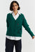 Woman wearing a green cardigan with a Snoopy design on a white background