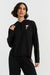 Woman wearing a black hoodie with a small logo on a white background