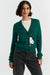 Woman wearing a green cardigan with a cartoon character design on a white background