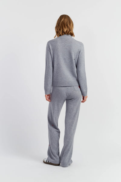 Woman wearing a gray suit on a white background