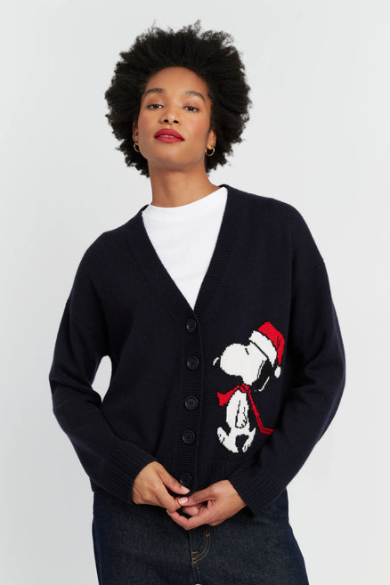Person wearing a black cardigan with a Christmas-themed design on a white background