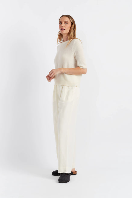 Woman wearing a white outfit on a white background