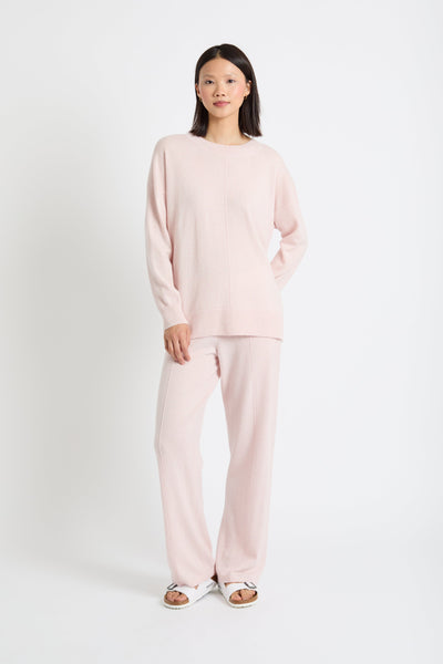 Woman wearing a pink outfit on a white background