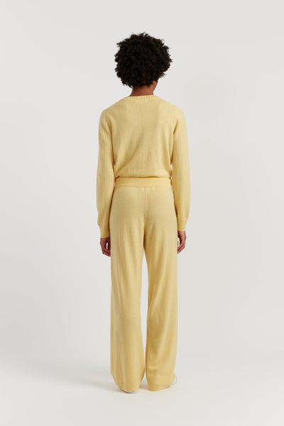 Person wearing a yellow outfit on a white background