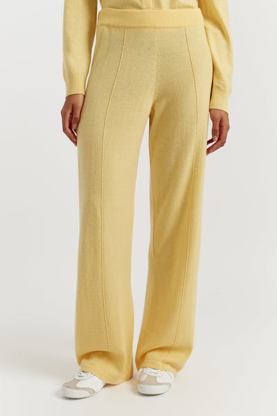 Yellow pants worn by a person on a white background