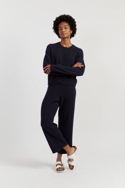 Person wearing a black outfit on a white background