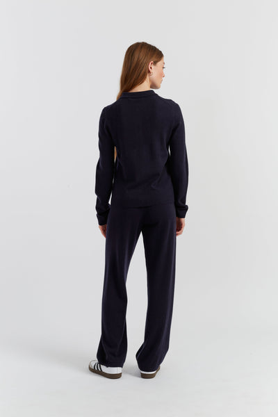 Person wearing a navy blue outfit on a white background