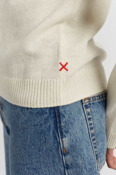 White sweater with a red 'X' on a white background
