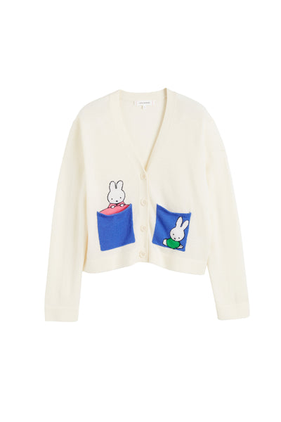 White cardigan with cartoon character patches on a white background