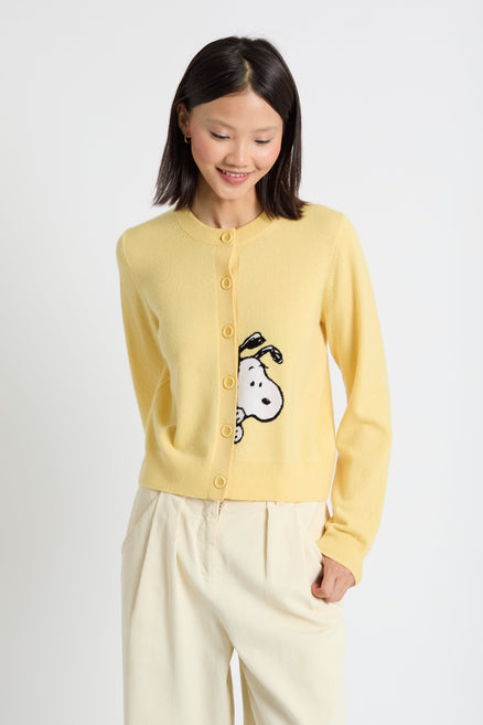 Woman wearing a yellow cardigan with a cartoon character on a white background