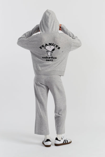 Person wearing a grey 'Peanuts Athletics Dept.' hoodie and pants on a white background