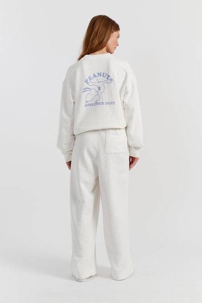 Person wearing a white sweatshirt with a logo on the back against a white background