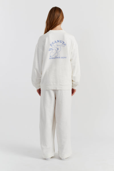 Person wearing a white sweatshirt with a logo on the back against a white background