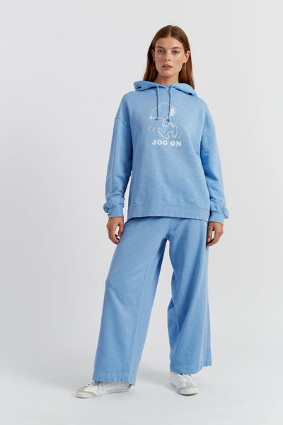 Woman wearing a blue hoodie and pants with 'Jog On' text on a white background