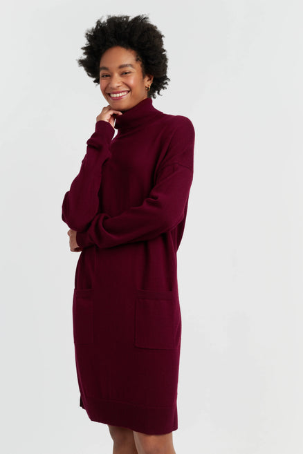 Woman wearing a burgundy dress against a white background