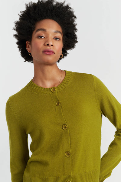 Woman wearing a green cardigan on a white background