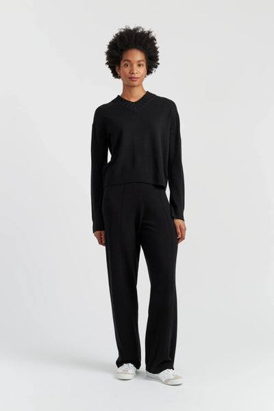 Person wearing a black outfit on a white background