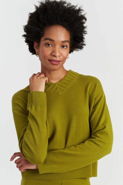 Woman wearing a green sweater on a white background