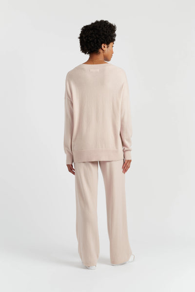 Person wearing a beige outfit on a white background