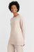 Woman wearing a light pink outfit on a white background