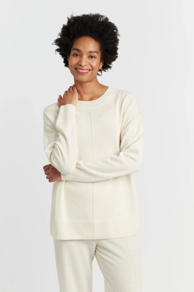 Person wearing a cream-colored outfit on a white background
