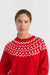 Woman wearing a red sweater with white pattern on a light gray background
