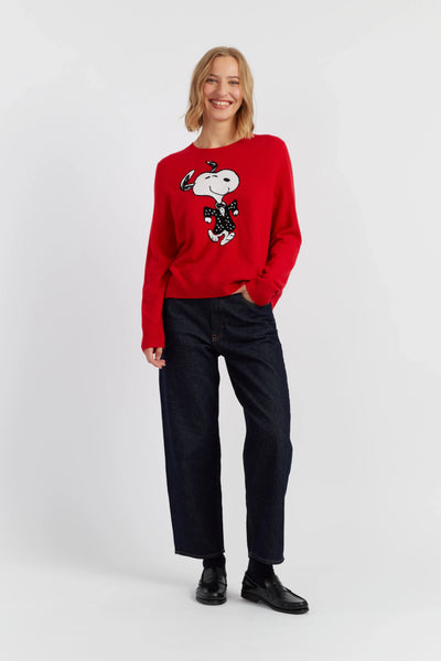 Person wearing a red sweater with a graphic design on a white background