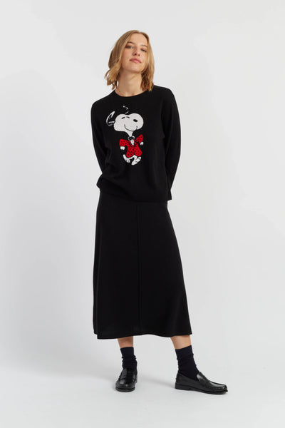 Person wearing a black sweater with a graphic design on a white background