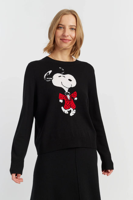 Woman wearing a black sweater with a cartoon character design on a white background