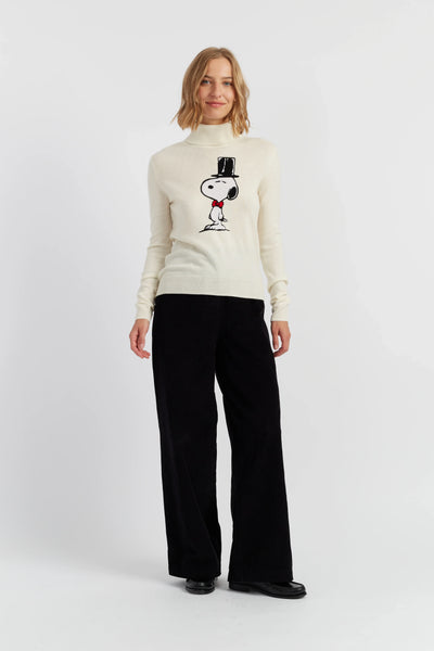 Woman wearing a white turtleneck sweater with a graphic design on a white background